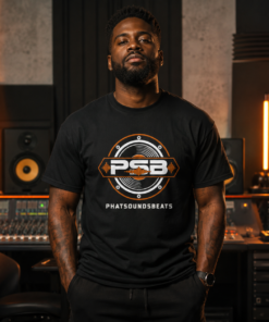 Black male producer wearing a PhatsoundsBeats PSB logo t-shirt in a recording studio
